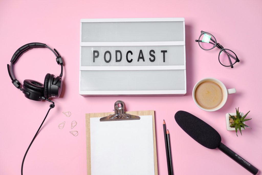 Music or podcast background with headphones, microphone, coffee